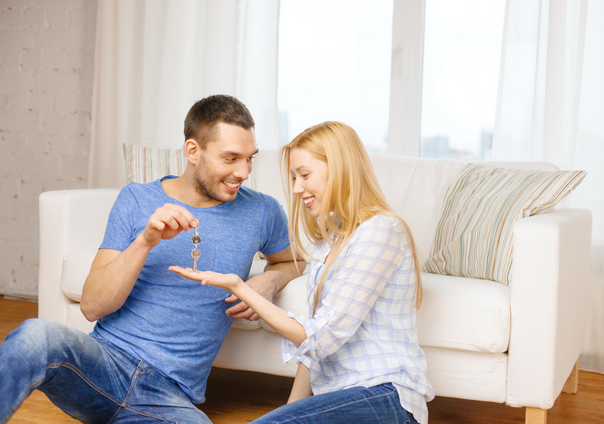 Man Giving Keys to Girlfriend or Wife at Home